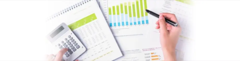 Accounting paperwork and a calculator on a desk