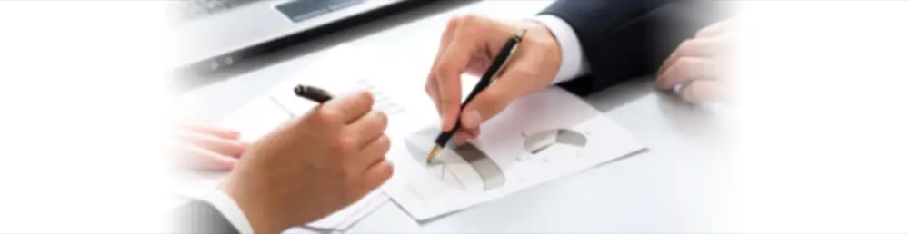 Hands signing tax paperwork